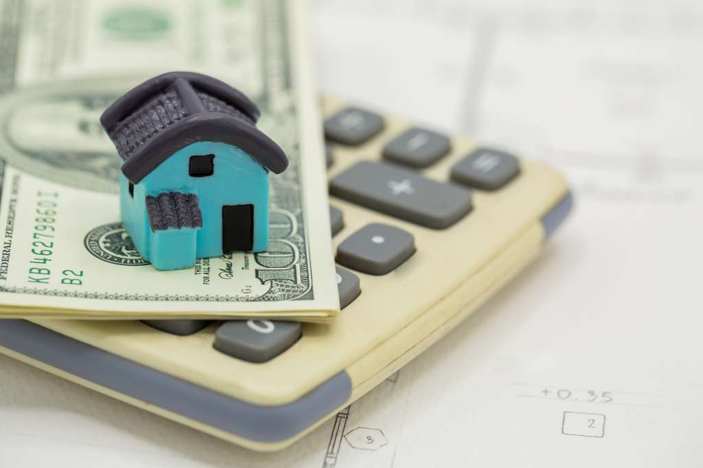 house calculator with dollar bills